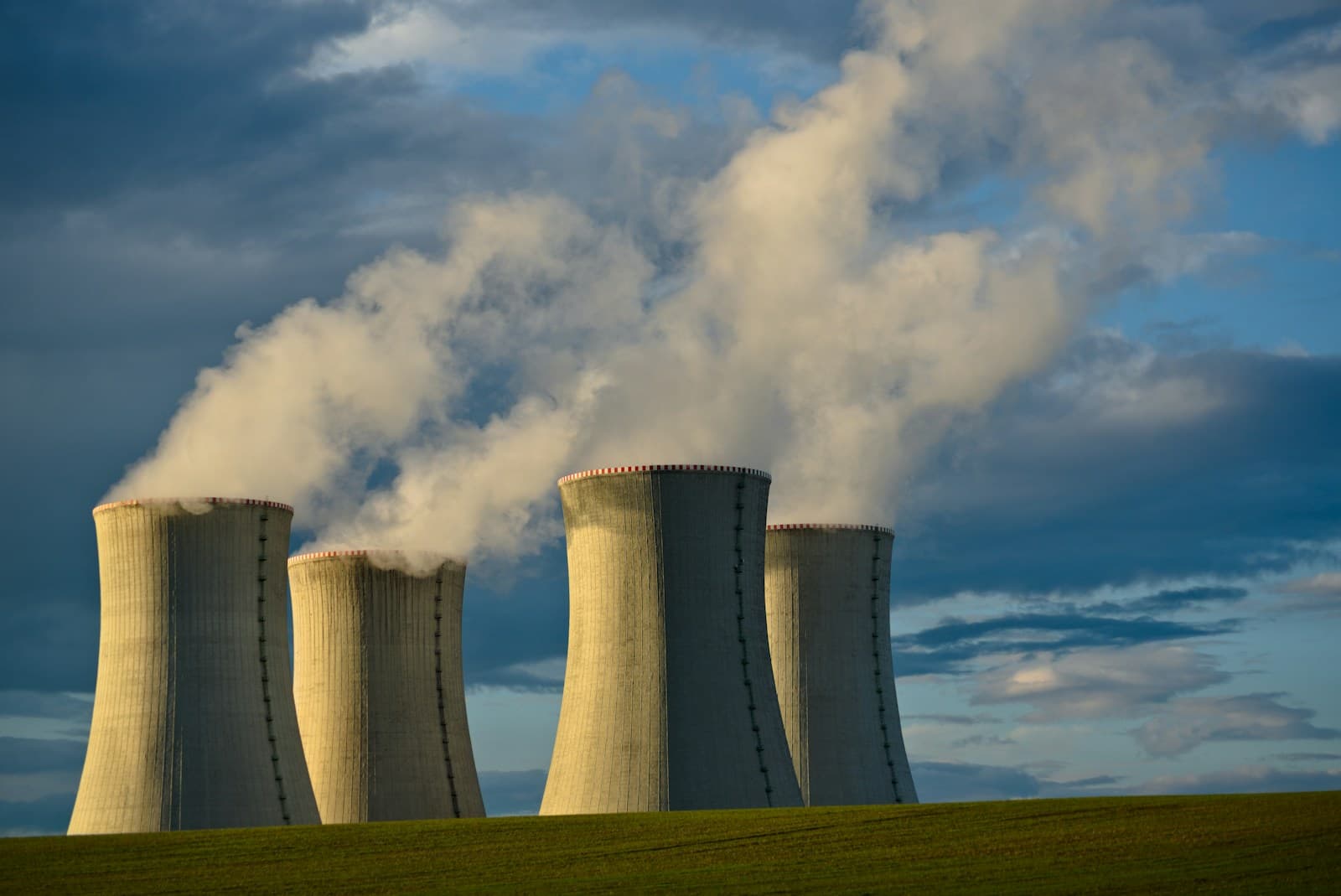 Concrete cooling towers of a nuclear power plant under a daytime sky